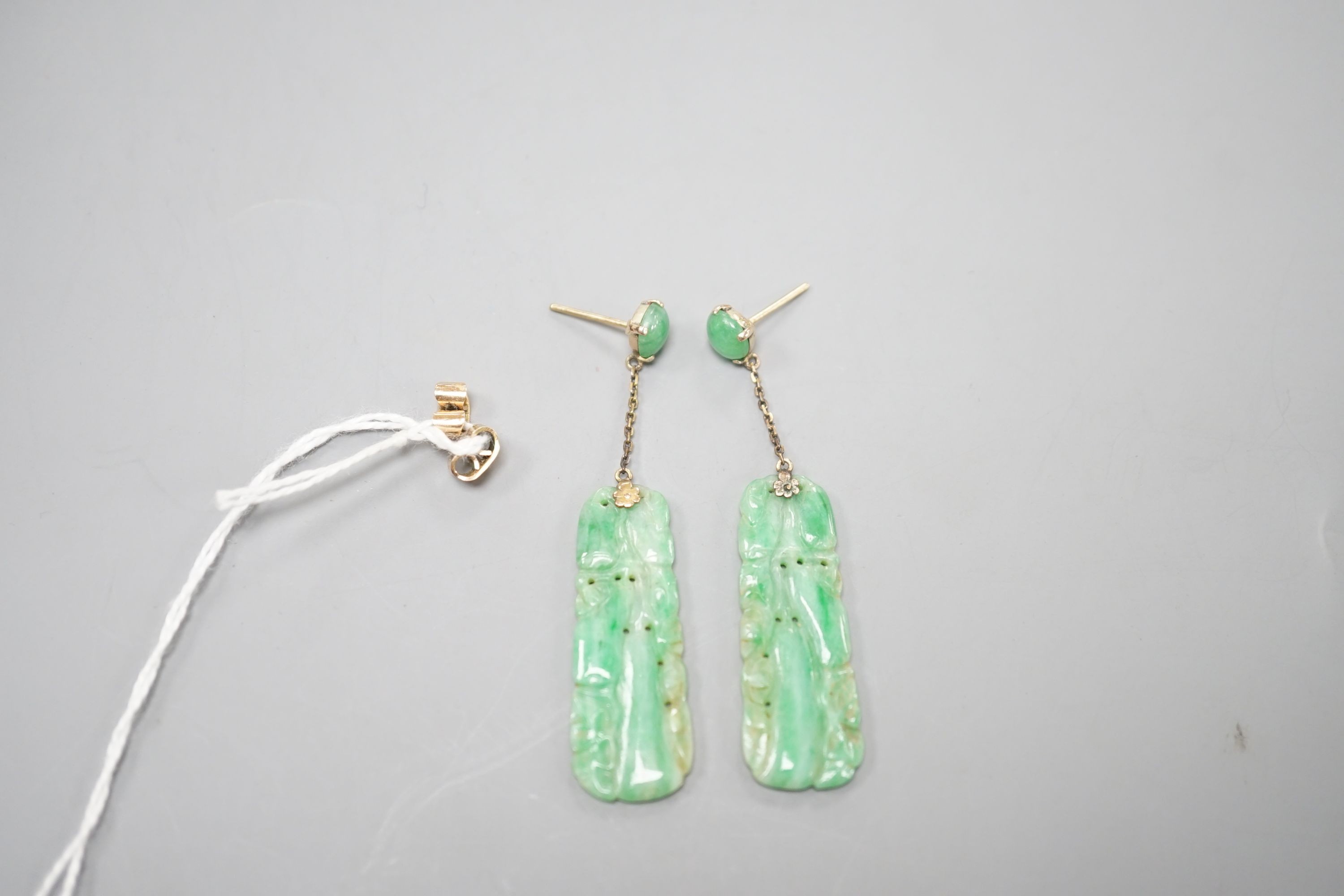 A pair of yellow metal mounted carved jade set drop earrings, overall 5cm, gross weight 7 grams.